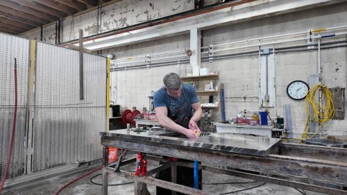 An example of a countertop receiving a laminated edge at Rumford Stone