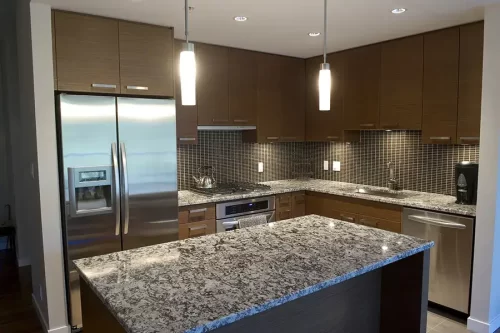 A quality granite countertop in a modern kitchen. Featuring black, gray, and white notes.